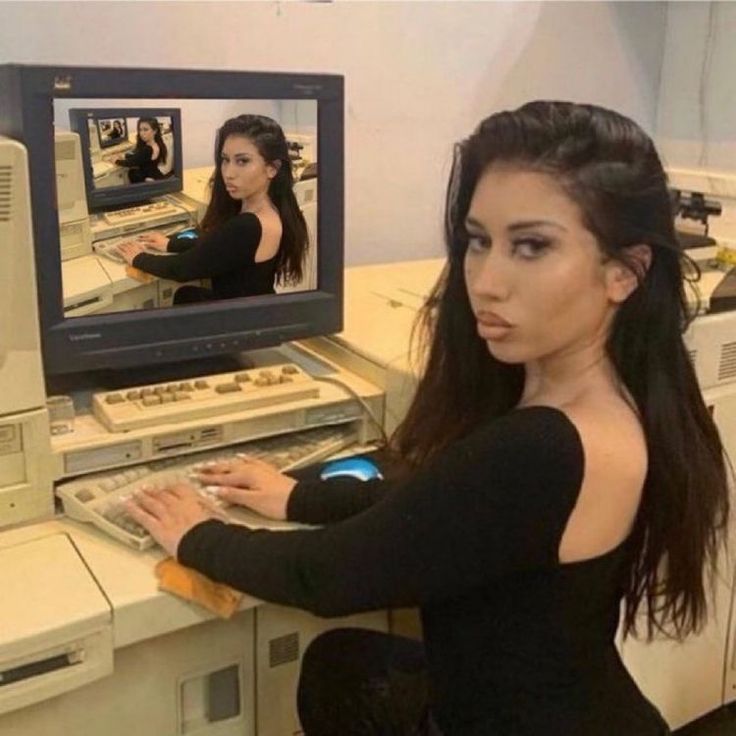 An image of Kali Uchis sitting at a computer